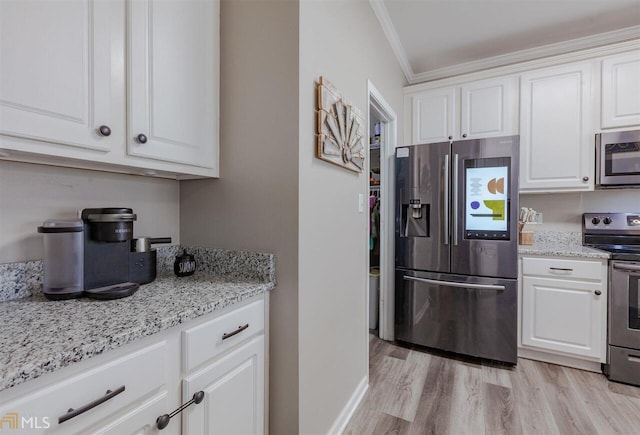 kitchen featuring stainless steel appliances, light wood-style floors, white cabinetry, and crown molding