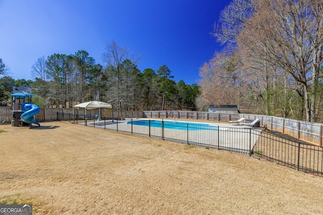 view of swimming pool with playground community, a patio area, fence, and a fenced in pool