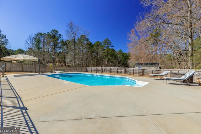 view of swimming pool with a patio area, a fenced backyard, and a fenced in pool