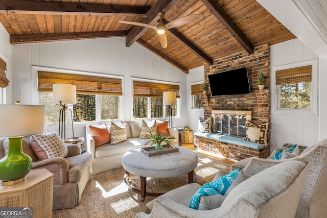 living room with a ceiling fan, wood ceiling, a fireplace, and vaulted ceiling with beams