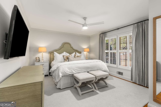 bedroom featuring a ceiling fan, visible vents, and crown molding