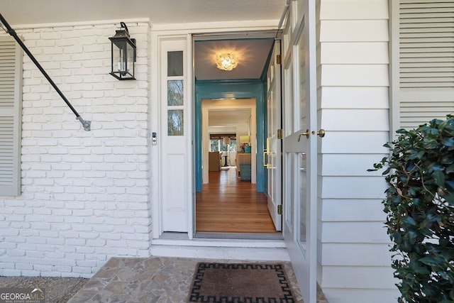 property entrance featuring brick siding