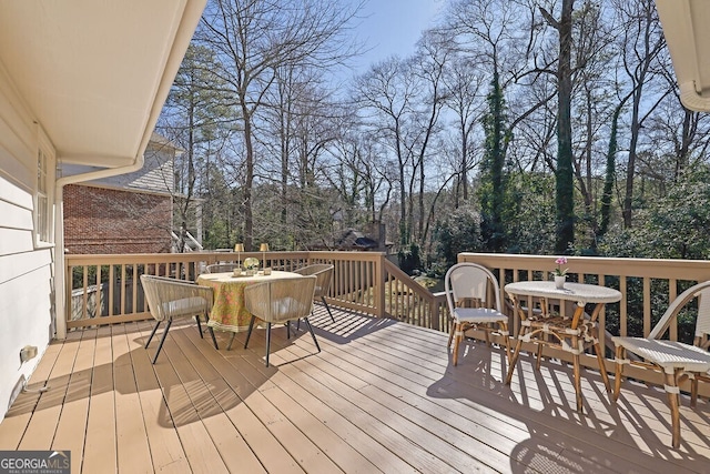 wooden deck featuring outdoor dining space