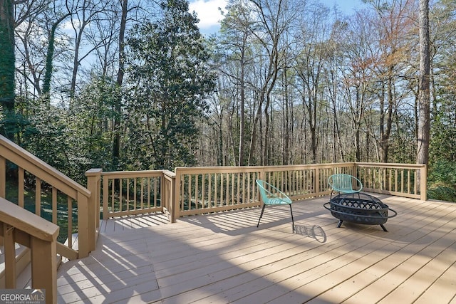 wooden deck featuring a fire pit