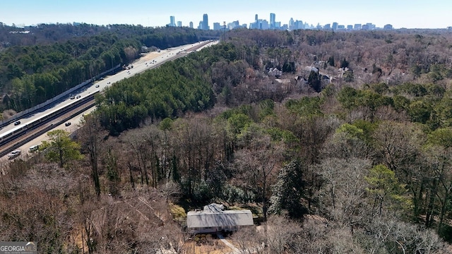 drone / aerial view with a view of city and a forest view