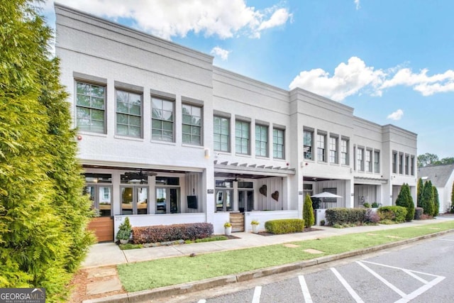 view of building exterior featuring uncovered parking