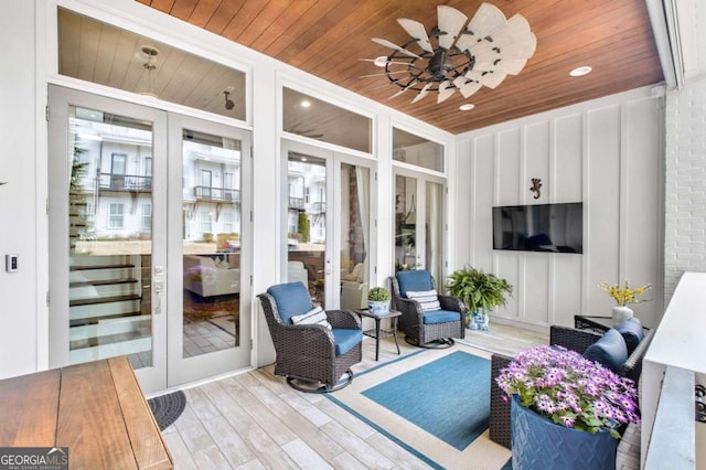 sunroom featuring wooden ceiling, ceiling fan, and french doors