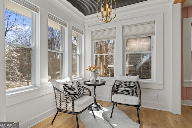 sunroom with an inviting chandelier