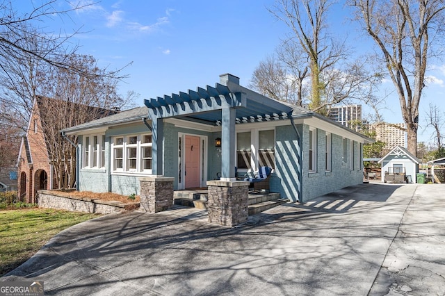 view of front of house featuring a porch, concrete driveway, and brick siding