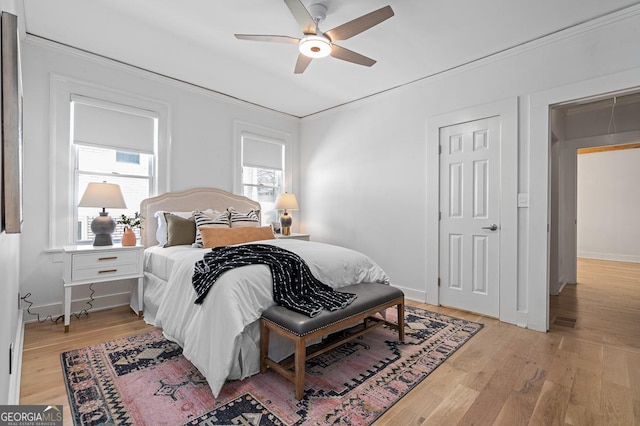 bedroom with ceiling fan, light wood-type flooring, and baseboards