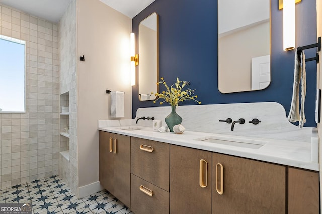 full bathroom with double vanity, walk in shower, and a sink