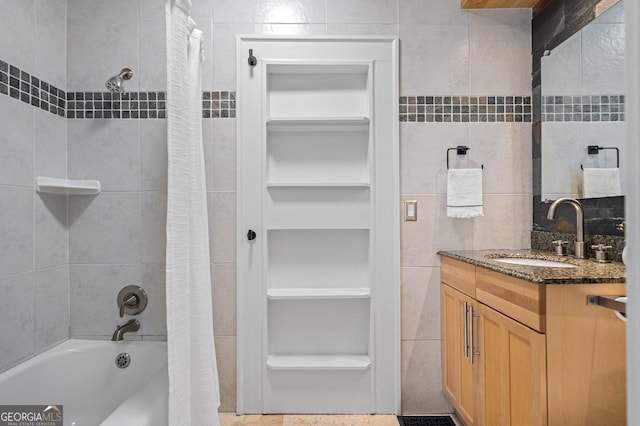 full bath with shower / bathtub combination with curtain, tile walls, and vanity