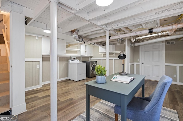 interior space with visible vents, washer and dryer, and wood finished floors