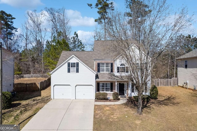 view of front of house with brick siding, concrete driveway, an attached garage, fence, and a front lawn