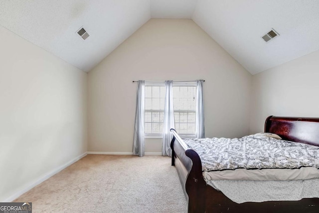 carpeted bedroom featuring lofted ceiling, visible vents, and baseboards