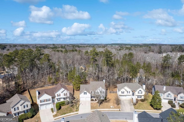 birds eye view of property with a residential view and a wooded view