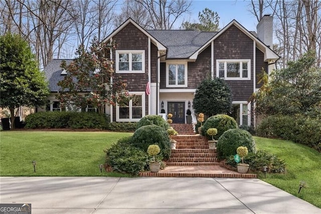 view of front of home featuring a chimney, french doors, and a front yard