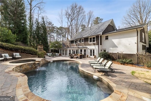 view of pool with a patio, an in ground hot tub, fence, french doors, and a fenced in pool