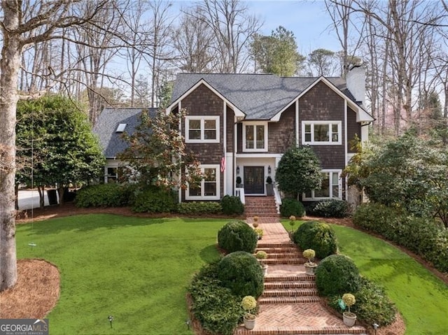 view of front of property with a front lawn and a chimney