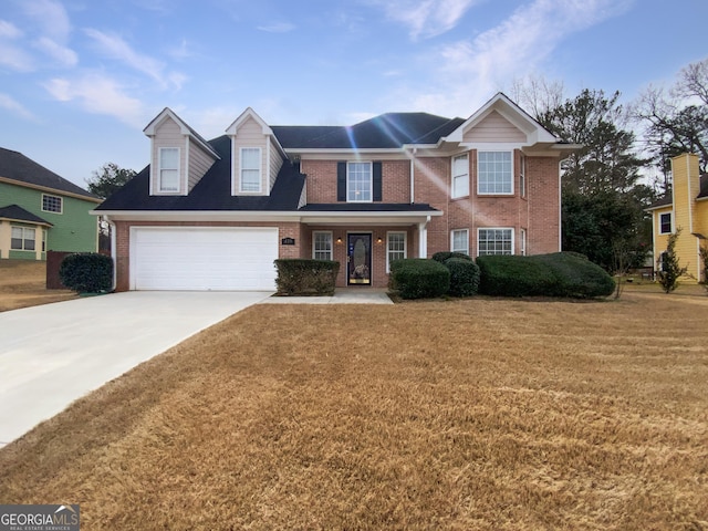 view of front of home featuring a garage, a front yard, concrete driveway, and brick siding