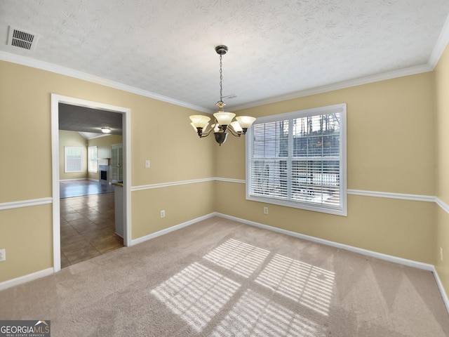 carpeted empty room featuring an inviting chandelier, baseboards, visible vents, and a textured ceiling