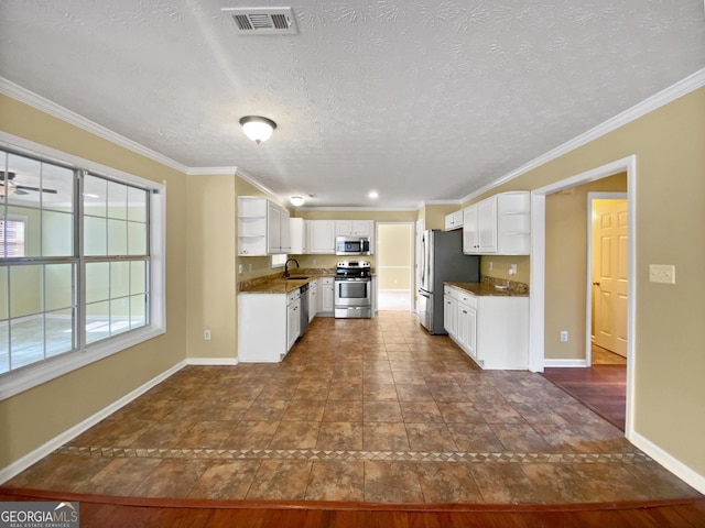 kitchen featuring stainless steel appliances, a sink, visible vents, white cabinets, and open shelves