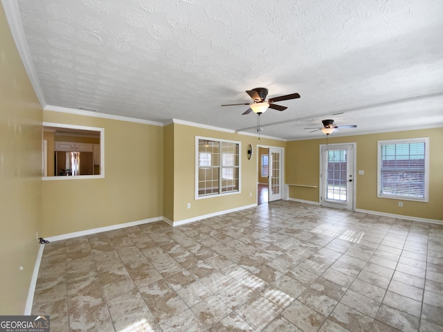 spare room with ornamental molding, visible vents, and baseboards