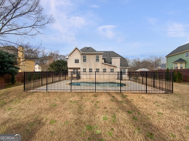 view of swimming pool featuring a patio area, a fenced backyard, a fenced in pool, and a yard