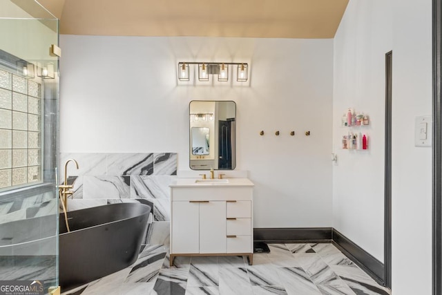 full bathroom with a soaking tub, plenty of natural light, vanity, and baseboards