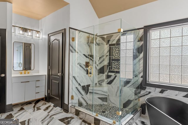 bathroom featuring a stall shower, a freestanding tub, and vanity