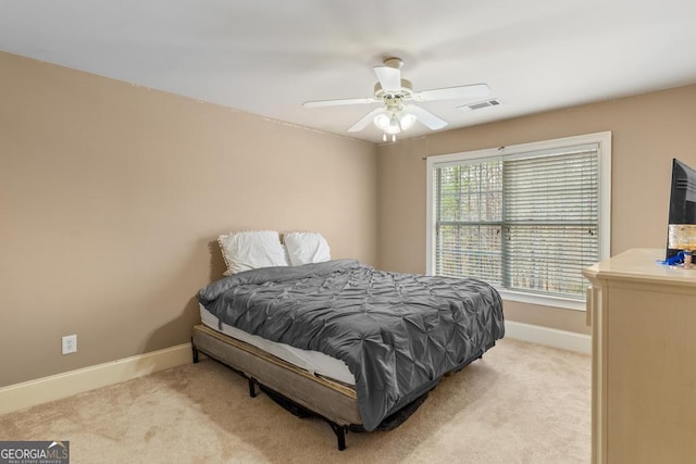 bedroom with baseboards, visible vents, a ceiling fan, and light colored carpet