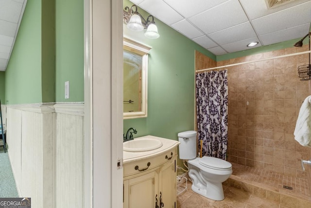 full bathroom with toilet, visible vents, vanity, a tile shower, and tile patterned floors