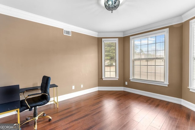 home office with baseboards, crown molding, visible vents, and wood finished floors