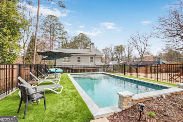 view of swimming pool featuring a fenced in pool, a yard, and a fenced backyard