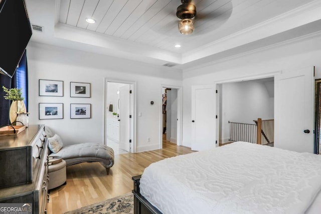 bedroom featuring baseboards, wood ceiling, wood finished floors, a tray ceiling, and recessed lighting