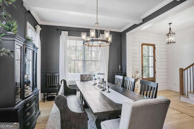 dining space with stairs, light wood-style floors, beamed ceiling, and an inviting chandelier