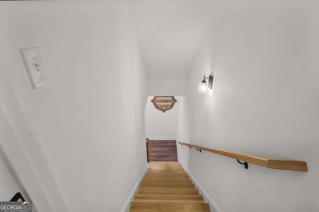 stairway featuring wood finished floors and baseboards