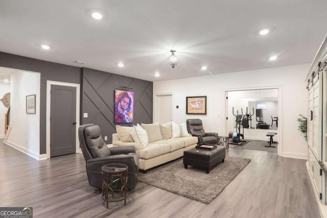 living room featuring baseboards, wood finished floors, and recessed lighting