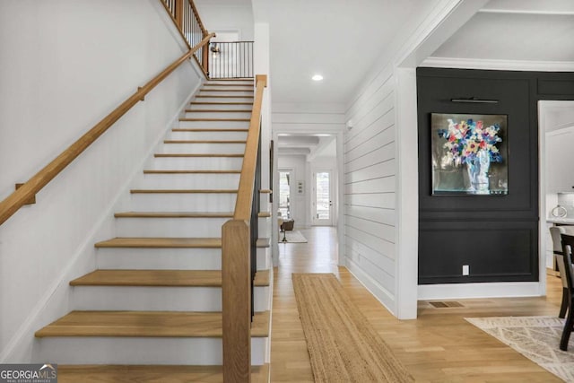 foyer with stairs, visible vents, wood finished floors, and recessed lighting