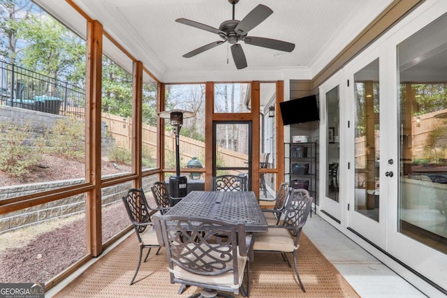 sunroom featuring a ceiling fan and a healthy amount of sunlight