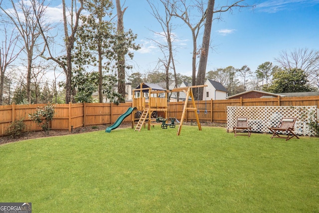 view of playground with a yard and a fenced backyard