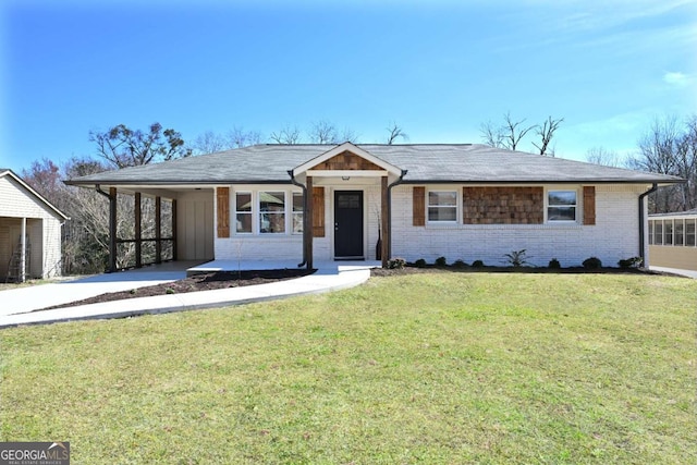 ranch-style house with brick siding, a front lawn, and a carport