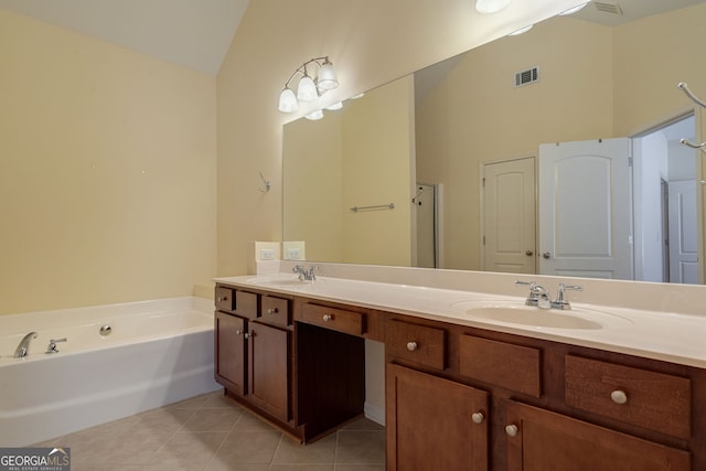 bathroom with tile patterned flooring, visible vents, vaulted ceiling, and a sink