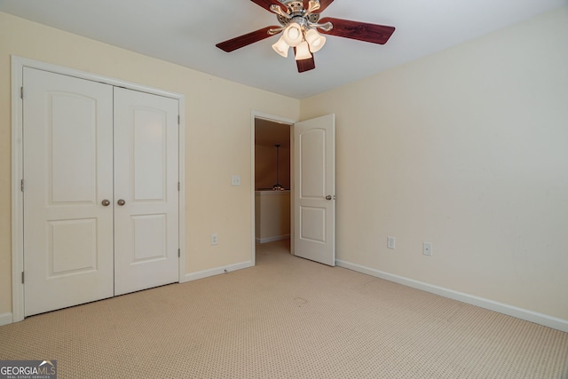 unfurnished bedroom featuring baseboards, a closet, a ceiling fan, and light colored carpet