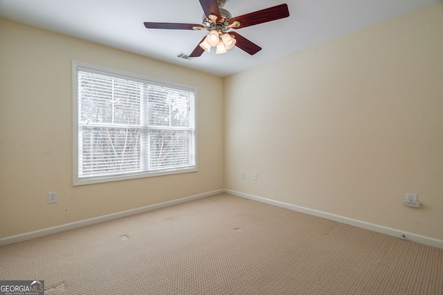 empty room with light carpet, ceiling fan, and baseboards