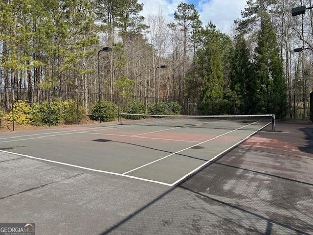 view of tennis court with fence