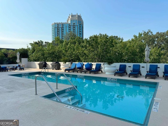 community pool with a patio area