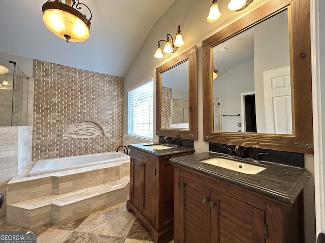 bathroom with vaulted ceiling, two vanities, a sink, and a bath