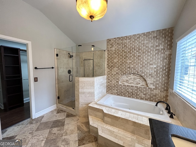 full bath featuring a garden tub, a sink, baseboards, vaulted ceiling, and a shower stall