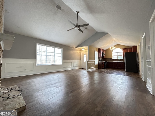 bonus room featuring visible vents, dark wood-style flooring, vaulted ceiling, a textured ceiling, and ceiling fan with notable chandelier